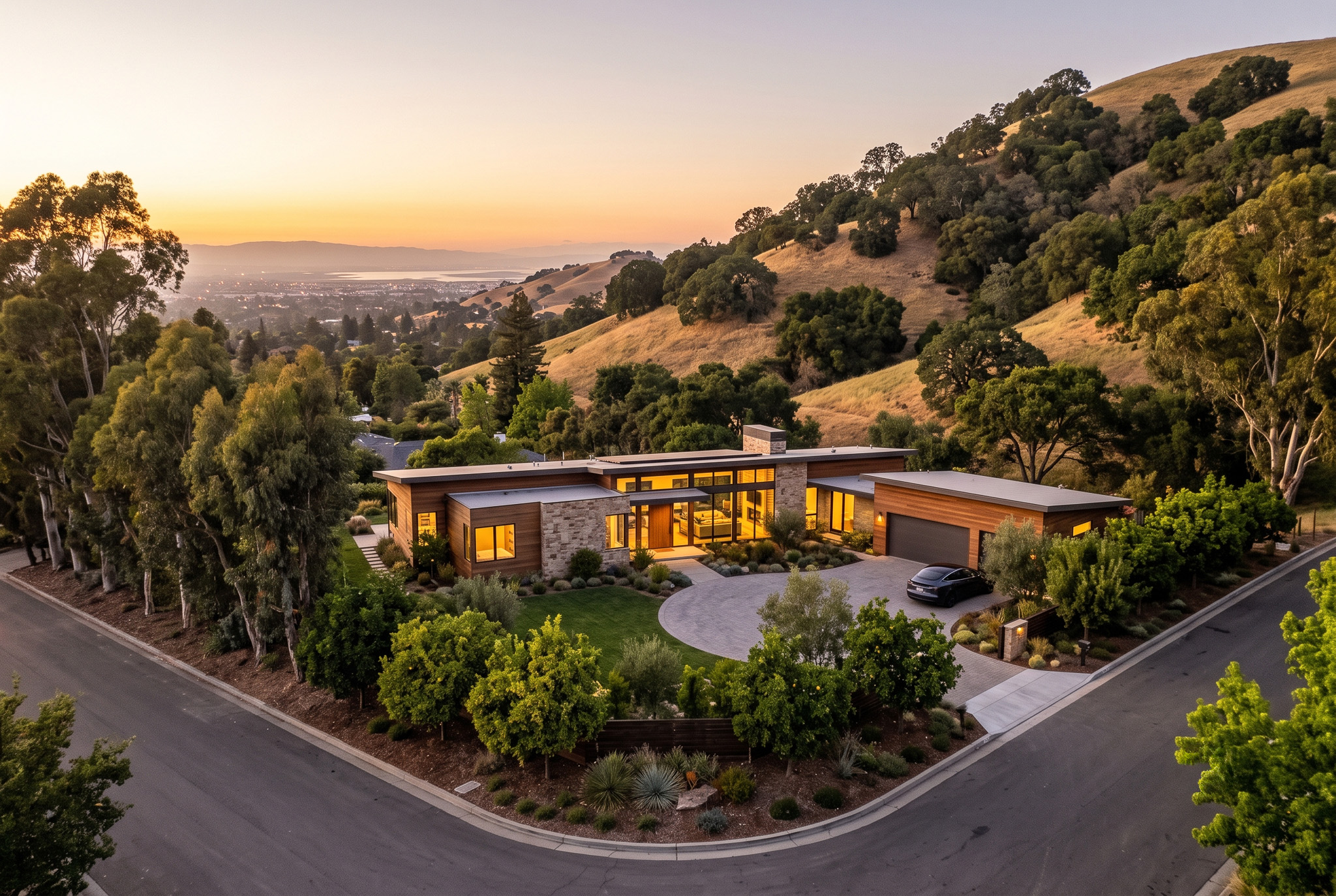 Artist's concept: a single modern estate on the level Morrison Canyon corner lot at golden hour