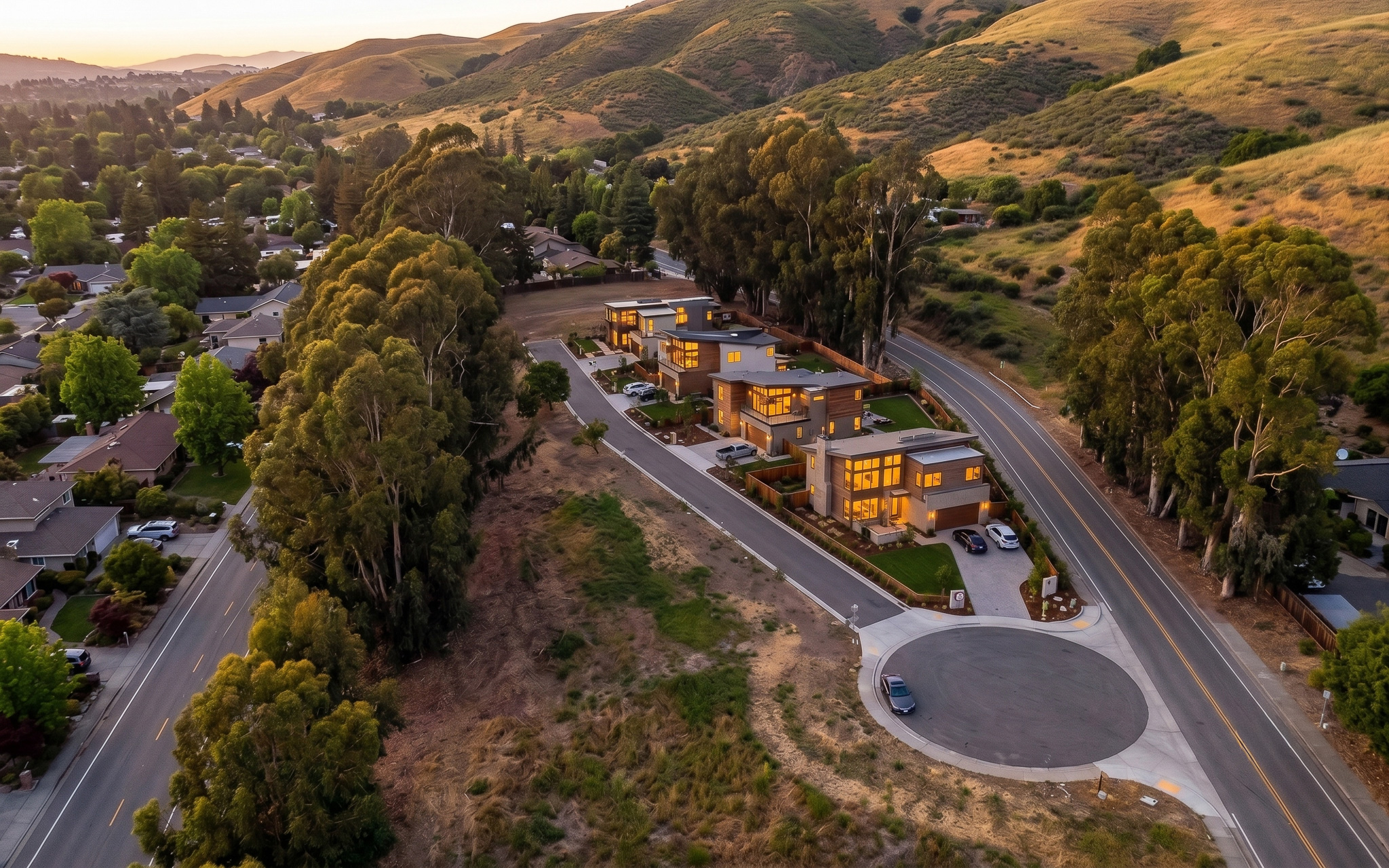 Artist's concept aerial: four modern homes on a shared private drive on the corner parcel